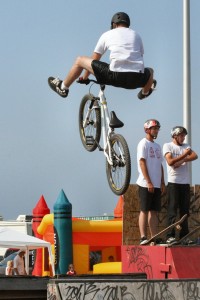 An amateur bicyclist pedals up ramps and flies over obstacles at a park in Oswego NY. 2007-07-28.